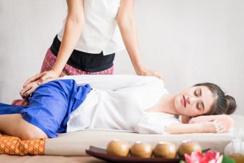 woman-lying-on-side-receiving-thai-massage